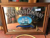 Full front view of the rectangular wooden framed mirror showing the complete painted text and ship on the reflective surface.