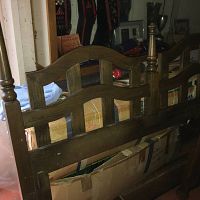 Wooden headboard showing full design with turned posts and dark oak finish.