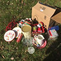 Photo showing the full assortment of Christmas items including mugs, plates, tins, pitcher, garland, and basket