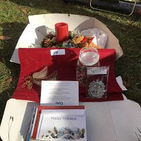Overview of lot showing advent wreath, candle, felt base, Christmas cards, angel wings decoration, and jar.