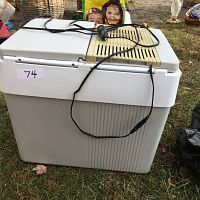 Photo of Koolatron P65 Kargo Kooler cooler showing the front and lid with electrical cord attached on top.