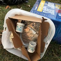 Top view showing power cords, two white ceramic light socket adapters packed in cardboard inside the cushion, and the deluxe heated seat cushion box.