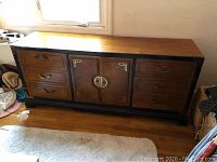 Full view of the Asian style dresser showing overall shape and brass hardware