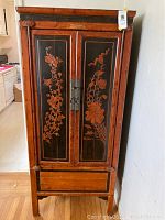 Front view of hutch showing carved floral design on door panels