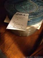 Stack showing 12 clear etched plates and 6 green plates with floral pattern