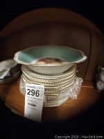 Stack of multiple Lataul China plates and a serving bowl on top, all featuring different fruit patterns, displayed on a wooden surface.