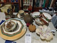 Photo showing the full porcelain collection on a table with various Royal Dalton, Adams, and floral pottery.