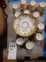 Top-down view of grouped tea cups surrounding a saucer showing design and quantity