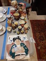 Overview of all jugs and collector plate on table.