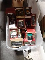 Tote bin filled with various boxed Star Trek Christmas ornaments including figurines and ships.