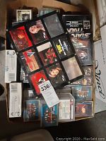 Box filled with a variety of Star Trek trading cards, including opened and sleeved cards, and 13 unopened boxes of Series II cards