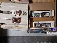 Multiple boxes filled with Star Trek trading cards showing a variety of characters and scenes from the series.