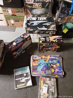 Photo showing multiple Star Trek model and toy boxes including AMT USS Enterprise kit, Star Trek Engineering Playset, and Klingon Attack Cruiser.