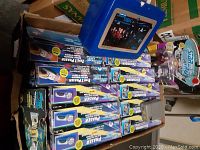Photo of multiple boxed Type 1 Phaser toys stacked with a Star Trek metal lunch box on top
