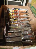 Box containing multiple Star Trek Deep Space Nine action figures in original packaging, arranged vertically.