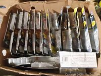 Photo of the lot showing all 11 figures in original packaging inside a cardboard box