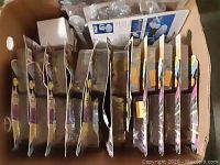 Photo showing multiple Star Trek action figures new in box arranged upright with blister packaging intact