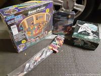 Photo showing Star Trek Bridge Playset box, action figure box, and kite in clear package along with a carrying case.