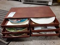 Brown partitioned holder box with collector plates inside