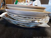 Side view of stacked plates showing thickness and some protective paper between plates