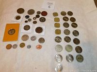 Full overview of the collection showing multiple tokens arranged in rows, some in protective holders, some loose.