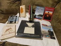 Photo showing nine Canadian history books on a couch, titles mostly visible, some ex-library usage.