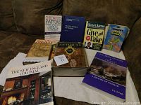 Photo of nine assorted non-fiction books arranged in rows on a fabric surface, clearly showing book titles and covers.