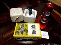 Three microscopes shown including the red Toys-R-Us model, Bausch & Lomb 100X, and Tasco with original packaging.