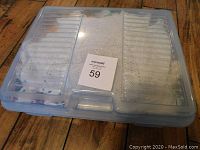 Plastic transparent storage case filled with folded lace items packed tightly inside, viewed from above.