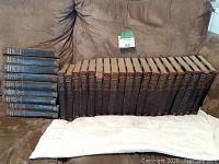 Full set of 29 leather-bound volumes displayed on couch