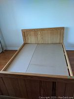 Angled front view of queen size wood bed frame with headboard and footboard