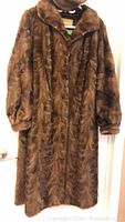 Front view of the full-length brown real fur coat showing texture and length