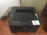 Top view of the Brother HL-2270DW printer showing the paper output tray and control buttons.