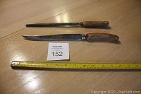 Side view of fixed blade knife and sharpening rod with ruler for scale, both featuring stag antler handles.