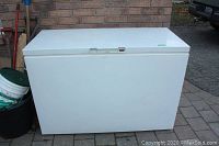 Front view of white chest freezer with closed lid.