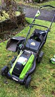 Greenworks electric lawn mower assembled with one grass catch bag attached and one spare bag