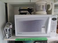 Panasonic microwave with items on top: Vitantonio waffler and juice blender. Cuisinart hand mixer to left side.