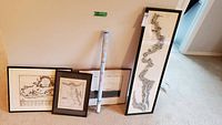 Overview of four framed maps and one rolled map in tube