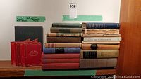 Full view of the set of 5 red booklets, Montreal book and other books stacked