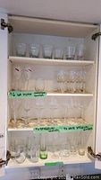Top shelf showing 6 cocktail glasses and various clear drinking glasses with thick bases