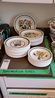 Three stacks of Portmeirion Botanica Gardens plates showing dinner, salad and bread plate varieties