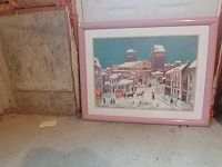 Framed Delacroix winter scene artwork positioned on a concrete floor against a wall, showing full piece within pink frame and clear view of winter urban scene with people and horse-drawn carriages.