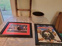 Shows two framed Chicken Little lithograph prints on table with ceramic crock and antique washboard in the background.