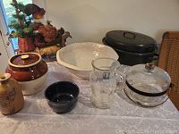 Photo showing crock with lid, vase, basin, glass mug, glass covered dish, black roasting pan