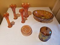 Full lot view showing the 4 vases, 2 candy dishes, and the fruit bowl with iridescent amber carnival glass finish