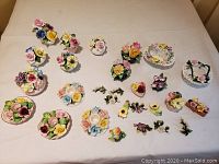 Top view of entire collection of porcelain flower figurines and small baskets showing variety and colors.