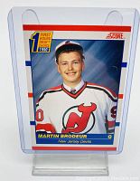 Front view of 1990 Score Hockey #439 Martin Brodeur rookie card with player portrait and team jersey.