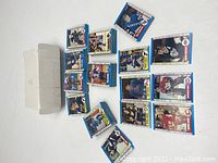 Multiple stacks of 1989-90 O-Pee-Chee hockey cards with blue borders fanned out showing some individual player card details and the original box.