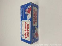 Blue sealed rectangular vending pack for 1988 Topps baseball picture cards, shrinkwrapped in plastic, with red and white branding and illustration showing kids trading cards.