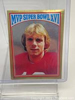 Front of the Joe Montana Super Bowl MVP sticker card with color photo and gold border.